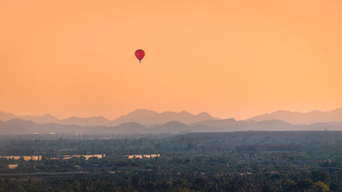 Hot air balloons against sky during sunset