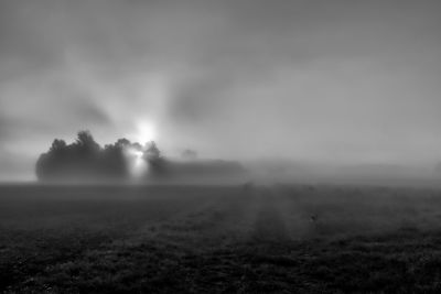 Scenic view of field against sky during foggy weather