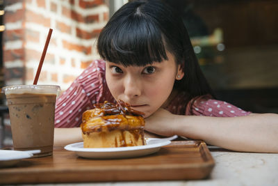 Portrait of girl with ice cream on table