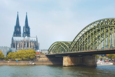 View of bridge over river against buildings