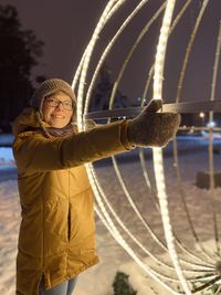 Portrait of young woman standing in snow