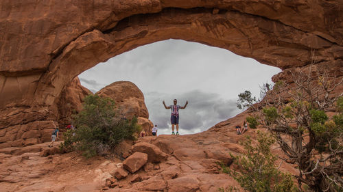 Full length of man standing on rock formation