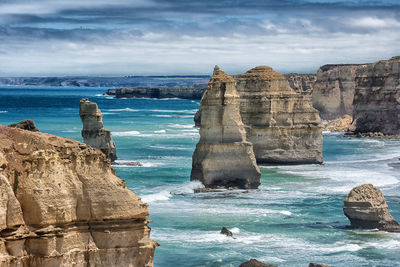 Scenic view of rocks in sea against sky