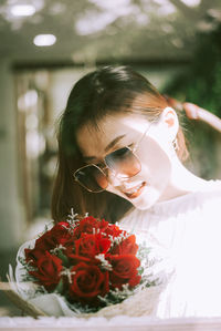 Portrait of woman with rose bouquet