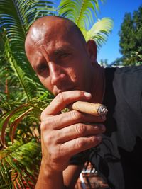 Close-up portrait of man smoking cigar