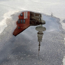 Reflection of building in puddle