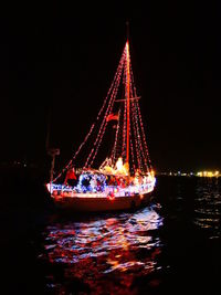 Illuminated ship in water at night