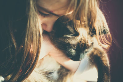 Close-up of girl holding cat