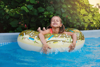 Portrait of boy swimming in pool