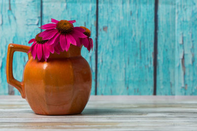 Close-up of pink flower in vase on table