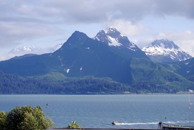 Scenic view of lake and mountains against sky