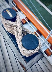 High angle view of rope tied on wood