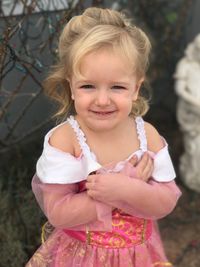 Portrait of cute smiling girl standing on field