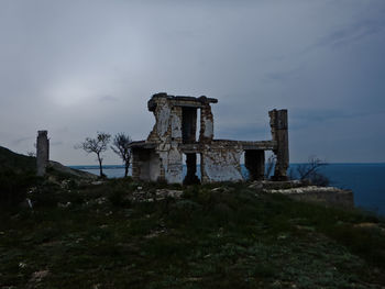 Old castle by sea against sky