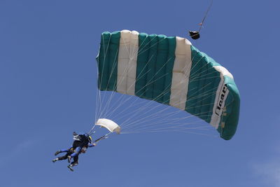 Low angle view of kite flying against clear blue sky