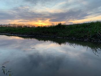 Scenic view of lake against sky during sunset