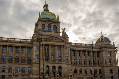 Low angle view of building against cloudy sky in prague 