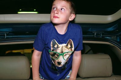 Boy in car at night