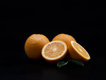 Close-up of orange fruit against black background