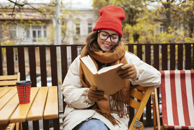 Portrait of smiling woman sitting on seat