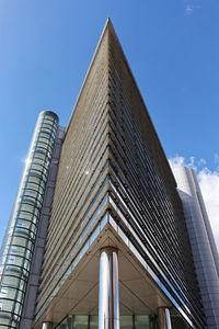 Low angle view of modern building against clear blue sky