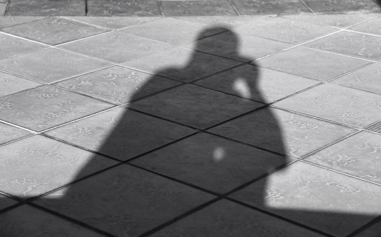 shadow, real people, focus on shadow, sunlight, one person, lifestyles, leisure activity, high angle view, men, day, outdoors, low section, people