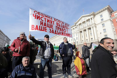 Group of people against buildings in city