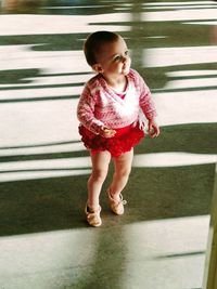 Full length of cute baby girl ballet dancing while looking away on floor