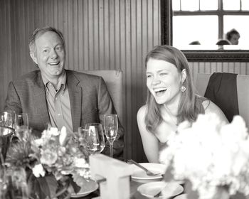 Happy business colleagues sitting on table at restaurant