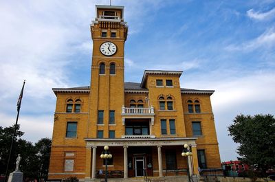 Low angle view of clock tower against sky