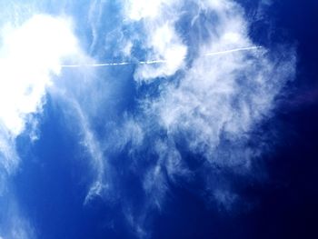 Low angle view of vapor trail in blue sky