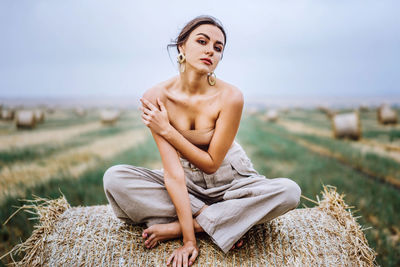 Full length of a young woman sitting on land