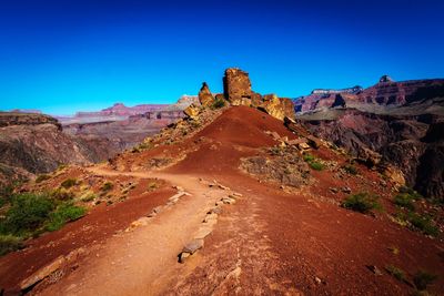 View of rock formations against blue sky