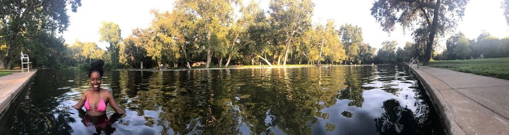 Reflection of trees in lake against sky