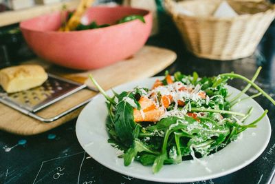 Close-up of served spinach salad with strawberry slices in plate