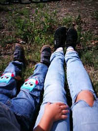 Low section of men sitting on land