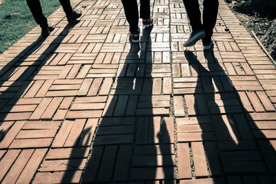 Low section of people walking on footpath