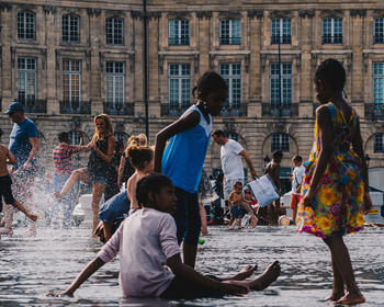 Group of people in front of buildings