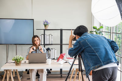 Behind the scene in studio. photographer count 1 2 3 before capture photo of beauty attractive girl