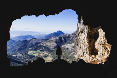 Silhouette man standing on mountain