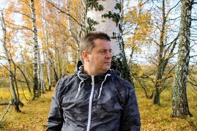 Portrait of man in forest during autumn