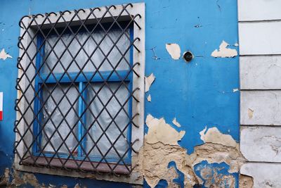 Close-up of blue window on wall of building