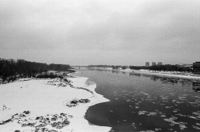 Scenic view of river against sky during winter