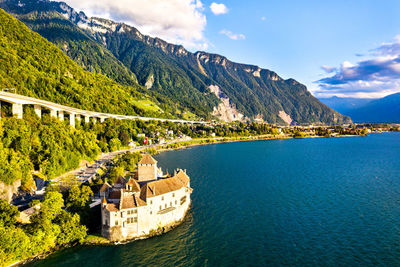 Scenic view of sea and mountains against sky