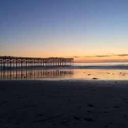 Pier over sea against clear sky