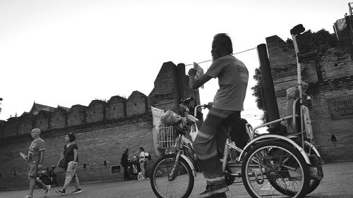 Man riding bicycle on street in city