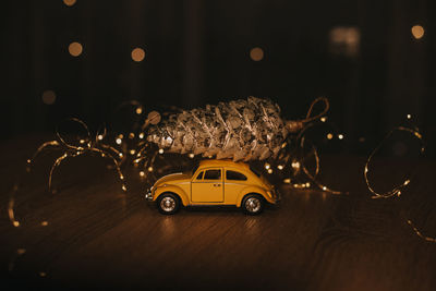 New year's decor. yellow volkswagen with a christmas cone on the table