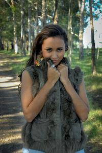 Portrait of beautiful young woman in forest