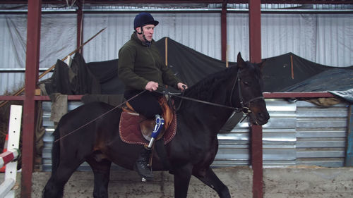 Portrait of man standing with horse