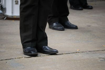 Low section of man standing on street